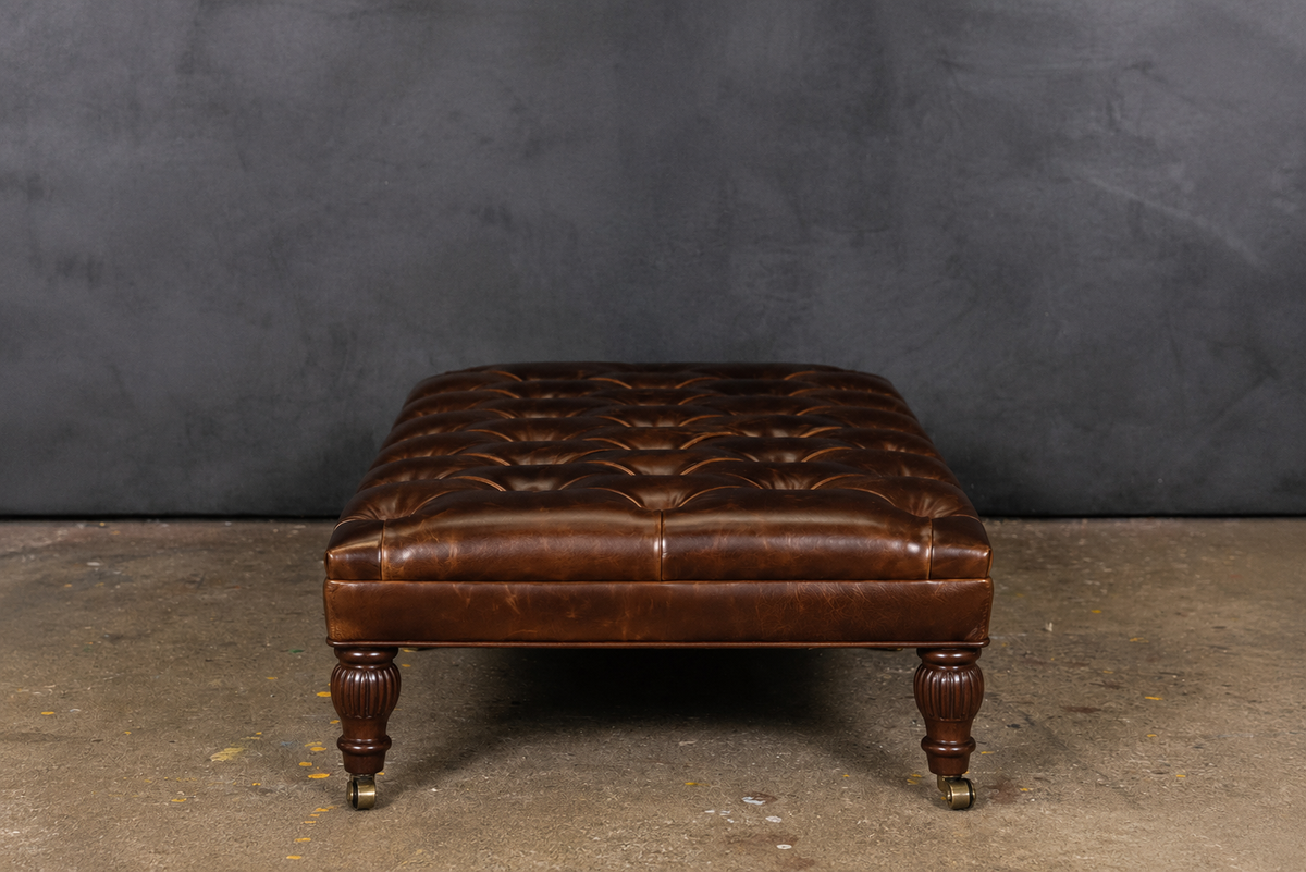 PERCY LEATHER CASTER TUFTED OTTOMAN